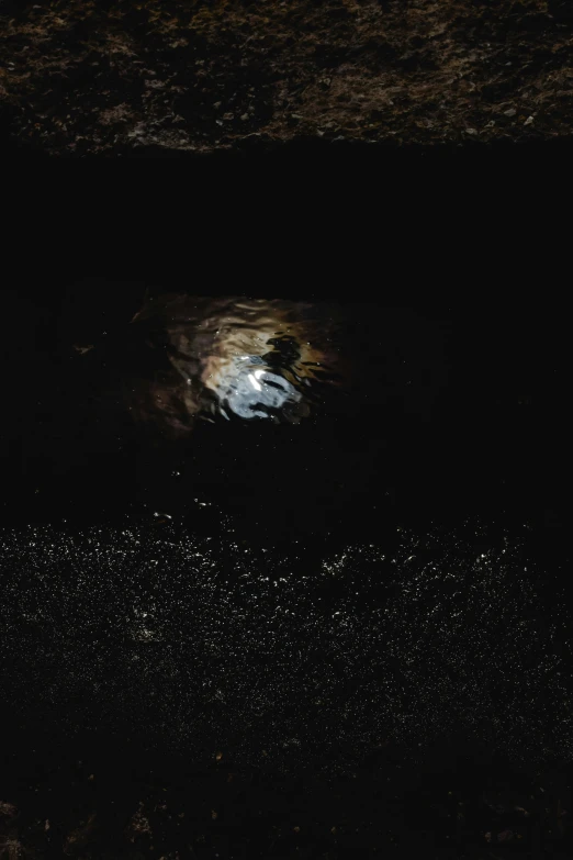 a man riding a surfboard on top of a wave, an album cover, by Jacob Toorenvliet, unsplash, conceptual art, 9 9 9 9 inside of a dark cave, moon craters, photograph from above, puddles