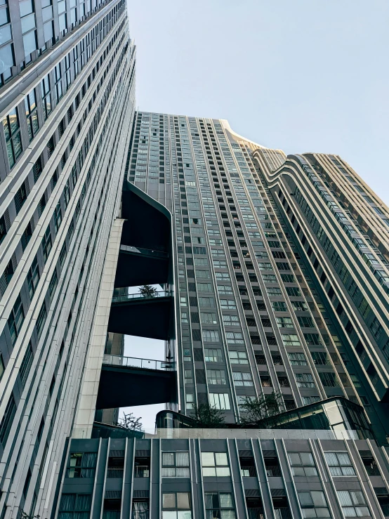 a couple of tall buildings next to each other, an album cover, inspired by Zaha Hadid, unsplash, in neotokyo, exterior photo, arasaka, hyperdetailed!