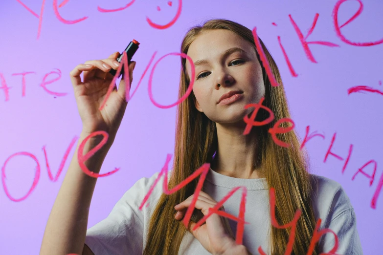 a woman writing on a wall with a marker, an airbrush painting, trending on pexels, portrait of kim petras, neon light language, school class, pink and purple