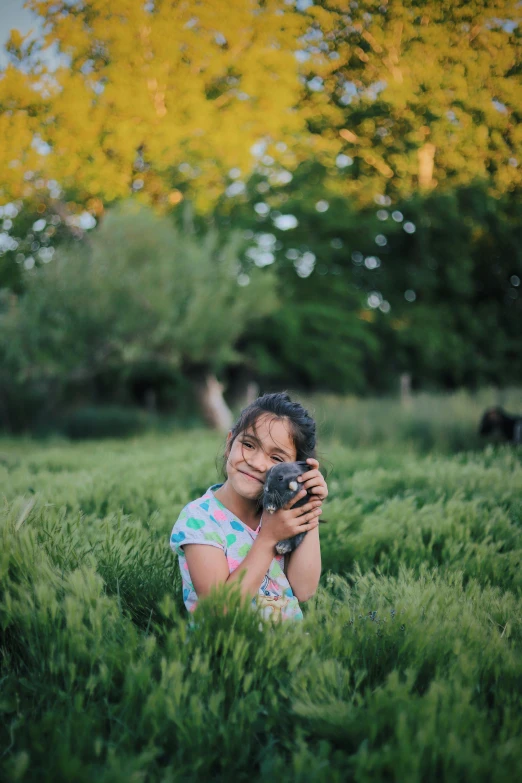 a woman holding a camera in a field, by Matt Cavotta, pexels contest winner, kids, subject: dog, medium format. soft light, friends