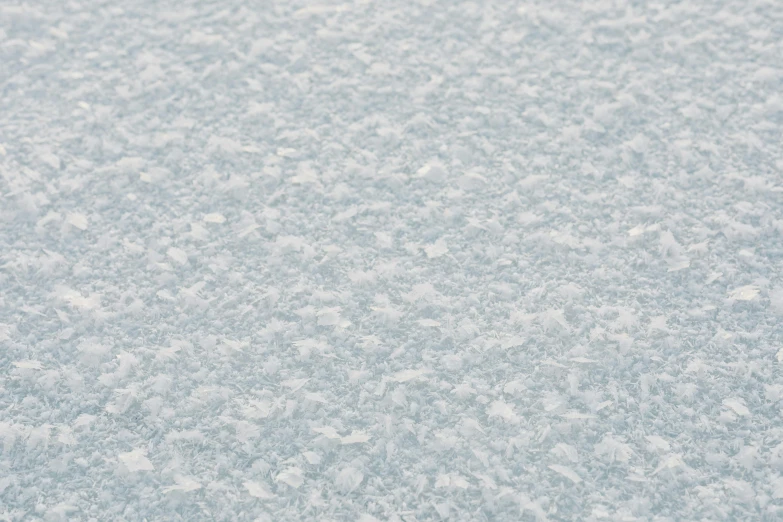 a pair of skis sitting on top of a snow covered ground, inspired by Vija Celmins, trending on reddit, seamless micro detail, pale blue fog, microscopic view, frosted glass