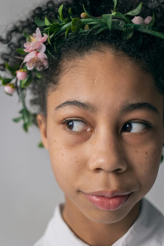 a young girl with a flower crown on her head, a character portrait, inspired by Martin Schoeller, trending on pexels, aida muluneh, loosely cropped, boy with neutral face, delicate features