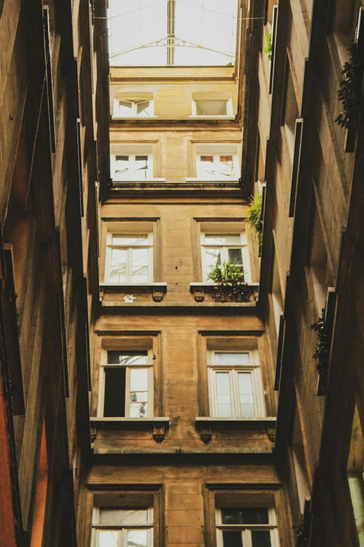 a very tall building with lots of windows, inspired by André Kertész, pexels contest winner, renaissance, alleyway, lviv, terraced, naples