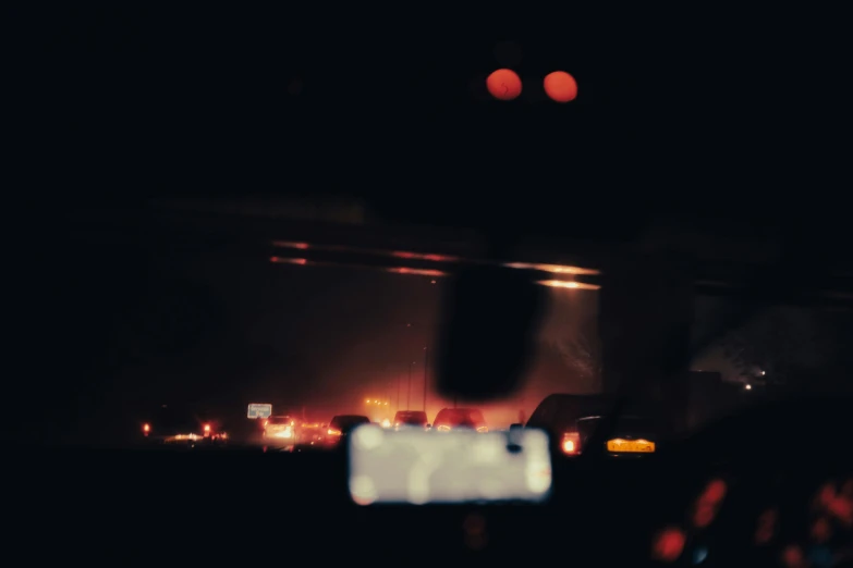 a person taking a picture of a fire at night, a picture, inspired by Elsa Bleda, visual art, car traffic, dark hazy room, search lights, highway