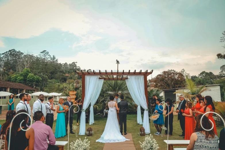 a group of people standing around a wedding ceremony, lush vista, unreal enging, d. i. y. venue, thumbnail