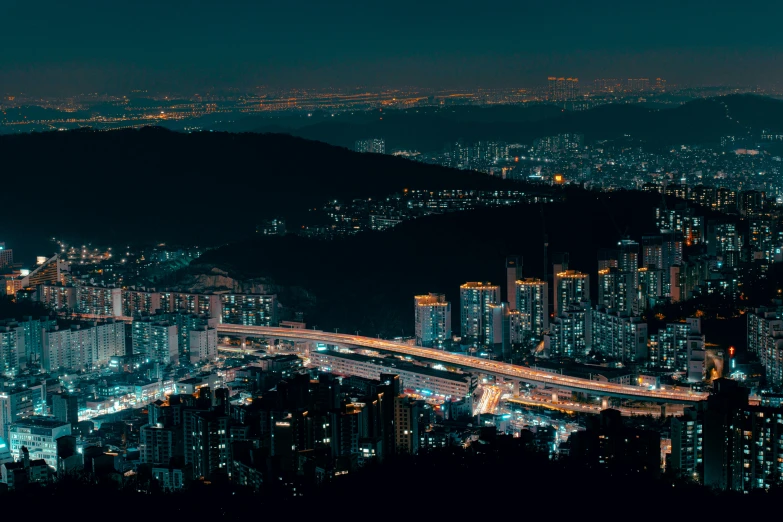 a view of a city at night from the top of a hill, inspired by Elsa Bleda, pexels contest winner, korean countryside, infrastructure, panoramic, korean