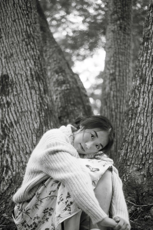 a black and white photo of a girl hugging a tree, inspired by Dorothea Lange, unsplash, covered with blanket, isabela moner, ✨🕌🌙, araki nobuyoshi