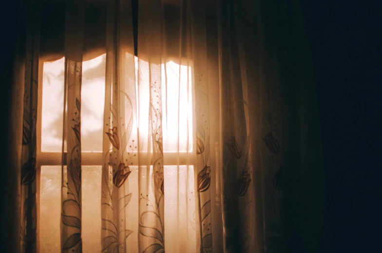 the sun shines through a window in a dark room, inspired by Elsa Bleda, pexels, curtains, a sunny bedroom, the sun shines in, warm sunlight shining in