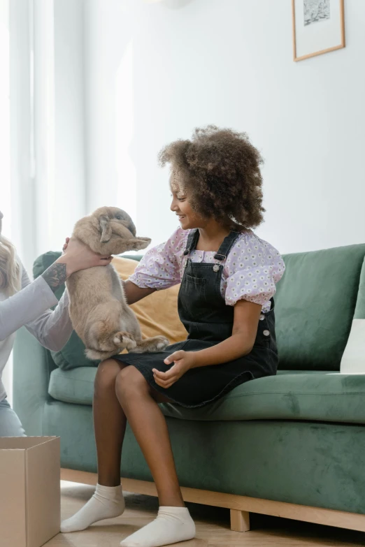 a woman sitting on a couch petting a small dog, pexels contest winner, renaissance, inspect in inventory image, families playing, cardboard, people at work