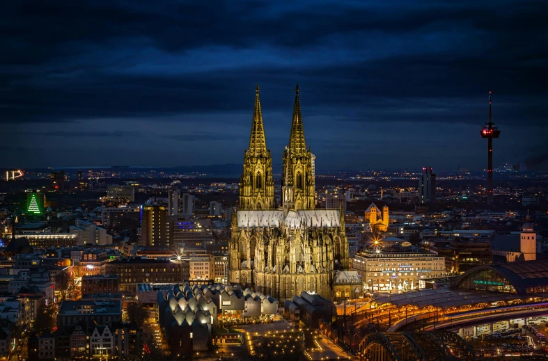 a large cathedral towering over a city at night, a colorized photo, pexels contest winner, german renaissance architecture, wide high angle view, majestic spires, minimalist