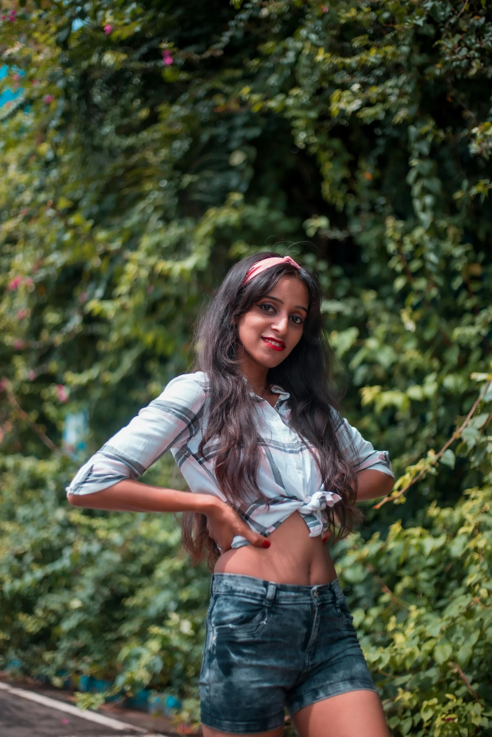 a woman standing on the side of a road, by Max Dauthendey, pexels contest winner, wearing a crop top, with ivy, avatar image, handsome girl