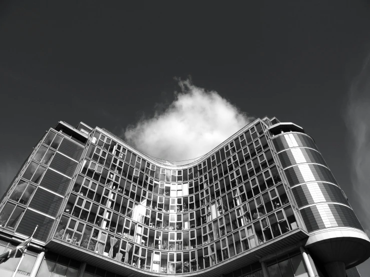 a black and white photo of a building, inspired by Ned M. Seidler, unsplash, cloud palace, espoo, on a bright day, curved