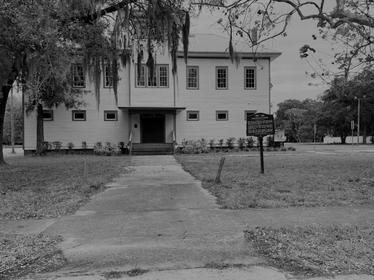 a black and white photo of a house, a black and white photo, by Maxwell Bates, private academy entrance, kicking a florida mansion, barracks, desaturated!!