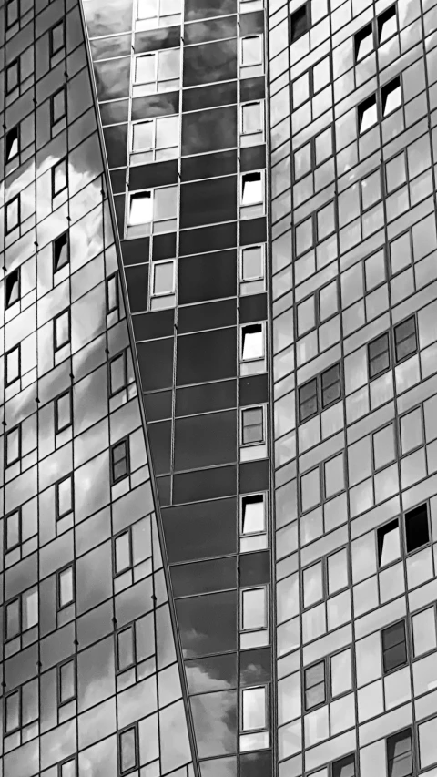 a black and white photo of a tall building, inspired by Peter Basch, unsplash, cubism, mirror and glass surfaces, square, metal panels, gleaming silver