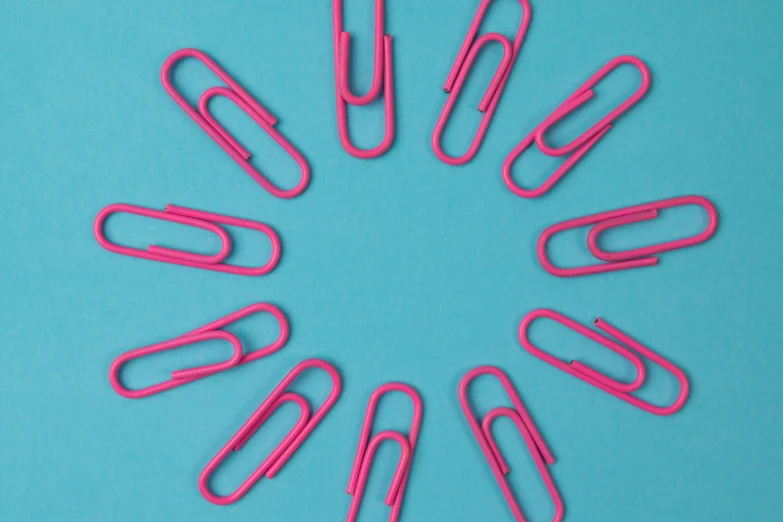 pink paper clips arranged in a circle on a blue background, by Julian Allen, pexels, pop art, surgical supplies, press release, 12, repeating