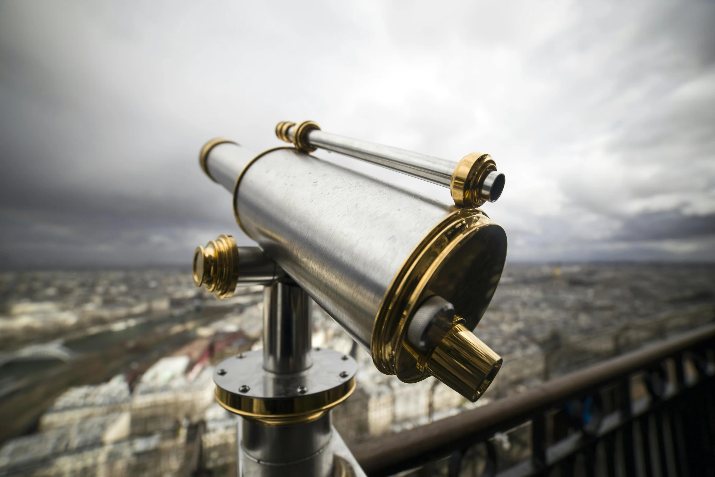 a telescope on top of a building overlooking a city, unsplash, art nouveau, aluminum, gold, close - up photograph, paris