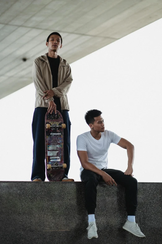 two men sitting on a ledge with a skateboard, lee madgwick & liam wong, slim and tall, poised, plans