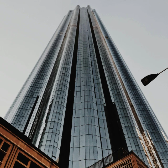 a tall building with a street light in front of it, an album cover, unsplash contest winner, hurufiyya, trump tower, exterior view, manchester, 2000s photo