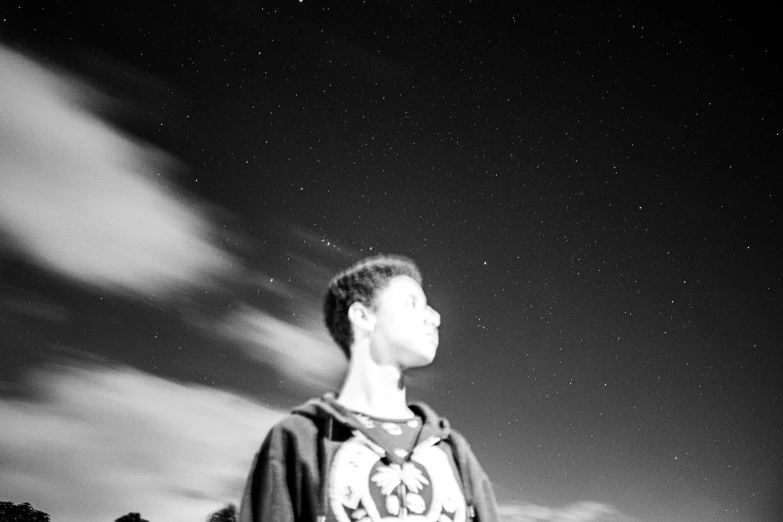 a black and white photo of a man holding a frisbee, by Kristian Zahrtmann, star(sky) starry_sky, teenage boy, detailed unblurred face, instagram picture
