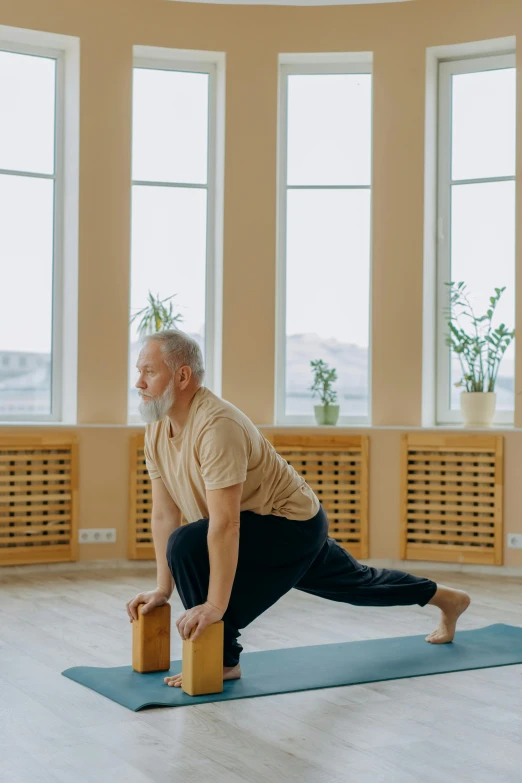 a man doing a yoga pose in a large room, pexels contest winner, portrait of hide the pain harold, low quality footage, profile image, brown