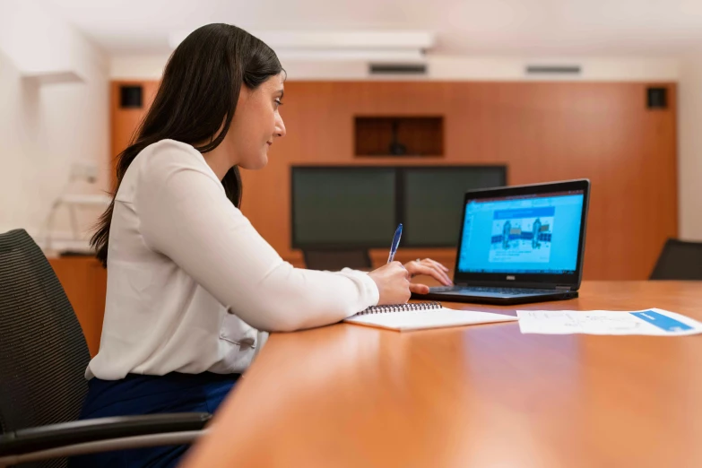 a woman sitting at a table working on a laptop, a digital rendering, pexels contest winner, in a meeting room, avatar image, professional closeup photo, professional profile picture