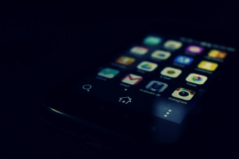 a close up of a cell phone in the dark, by Android Jones, unsplash, realism, square, vintage color, ios, multi-dimensional