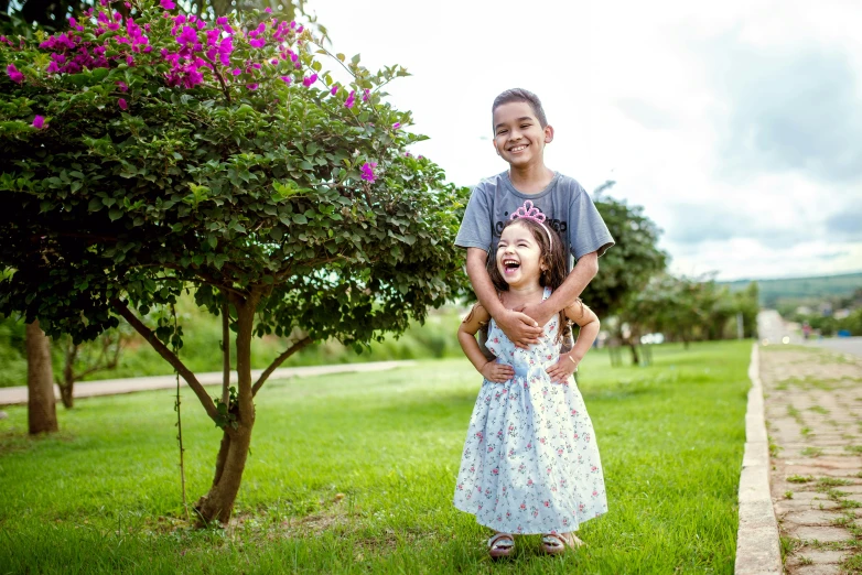 a couple of kids that are standing in the grass, a portrait, by Sam Dillemans, pexels, happening, hispanic, floral, 15081959 21121991 01012000 4k, both laughing