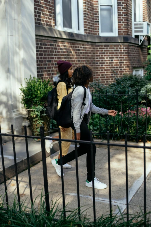 a couple of people walking down a sidewalk, heidelberg school, imaan hammam, alexis franklin, private school, concrete jungle