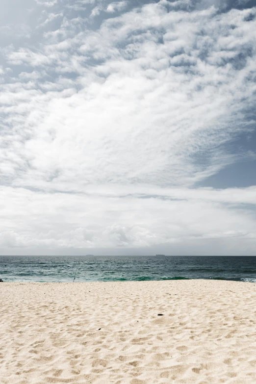 a man riding a surfboard on top of a sandy beach, by Nina Hamnett, trending on unsplash, minimalism, round clouds, sydney, viewed from the ocean, color”