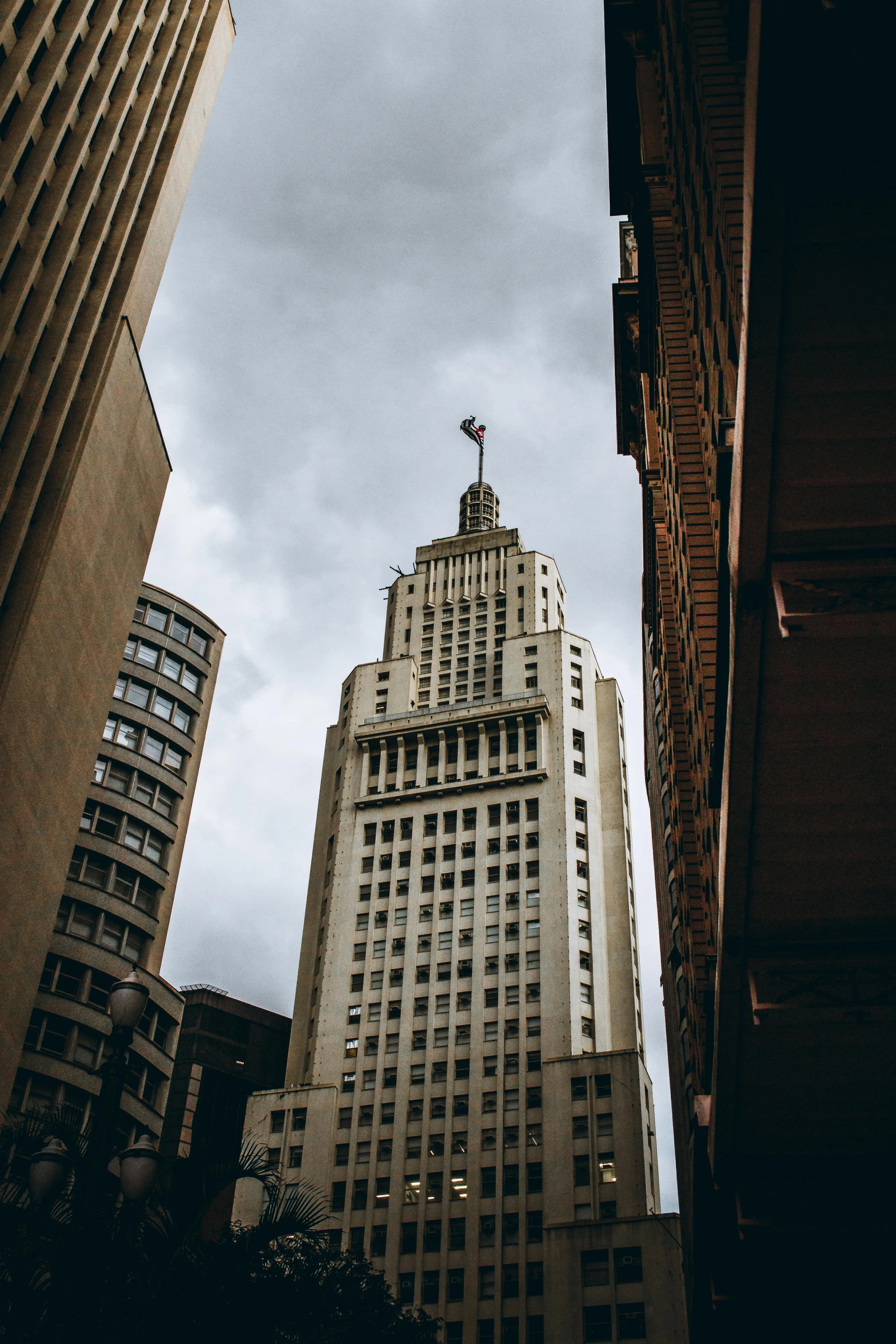 a tall building sitting in the middle of a city, looking up at the camera, louisiana, chile, cinematic photo