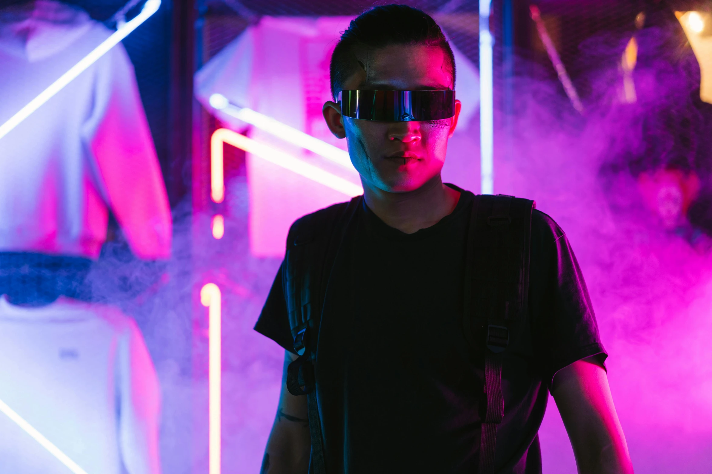 a man standing in front of neon lights, cyberpunk art, pexels contest winner, wearing 3 d glasses, asian man, an edgy teen assassin, futuristic fashion show