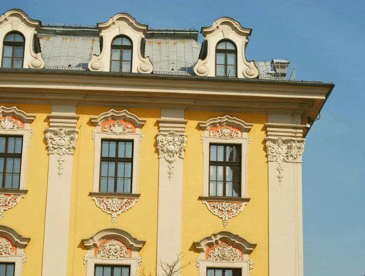 a yellow building with a clock on top of it, a photo, inspired by Károly Markó the Elder, rococo, house windows, exterior, square, low-angle