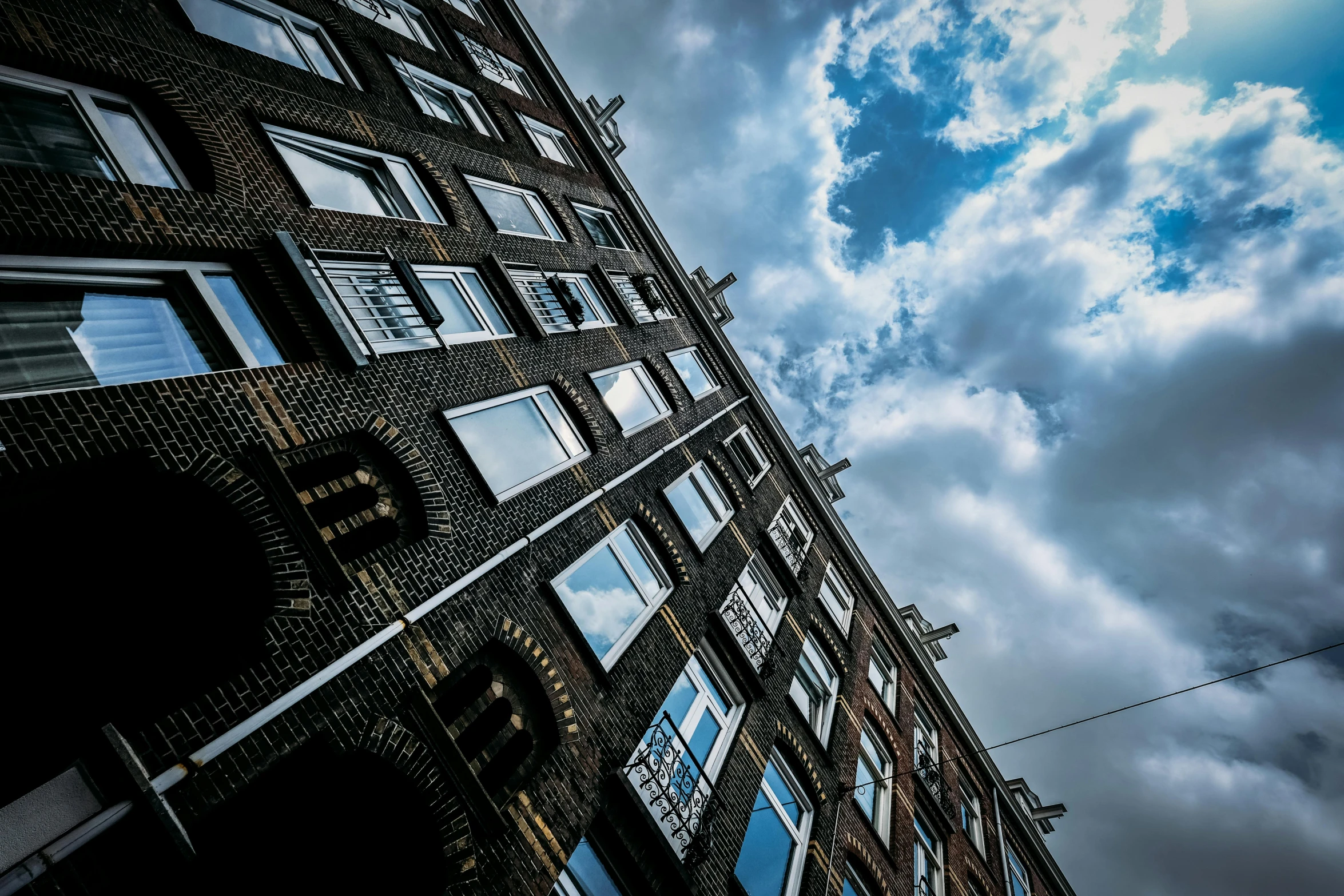 a clock that is on the side of a building, a photo, by Andries Stock, pexels contest winner, high clouds, amsterdam, thumbnail, pov photo