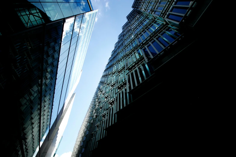 a couple of buildings that are next to each other, by Dave Allsop, unsplash, modernism, show from below, foster and partners, taken in the late 2000s, slide show