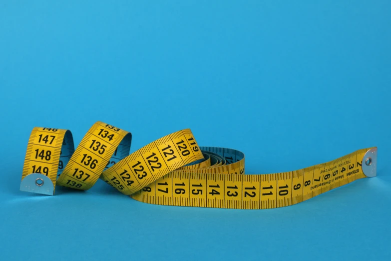 a measuring tape sitting on top of a blue surface, profile image, thumbnail, full body image, less detailing