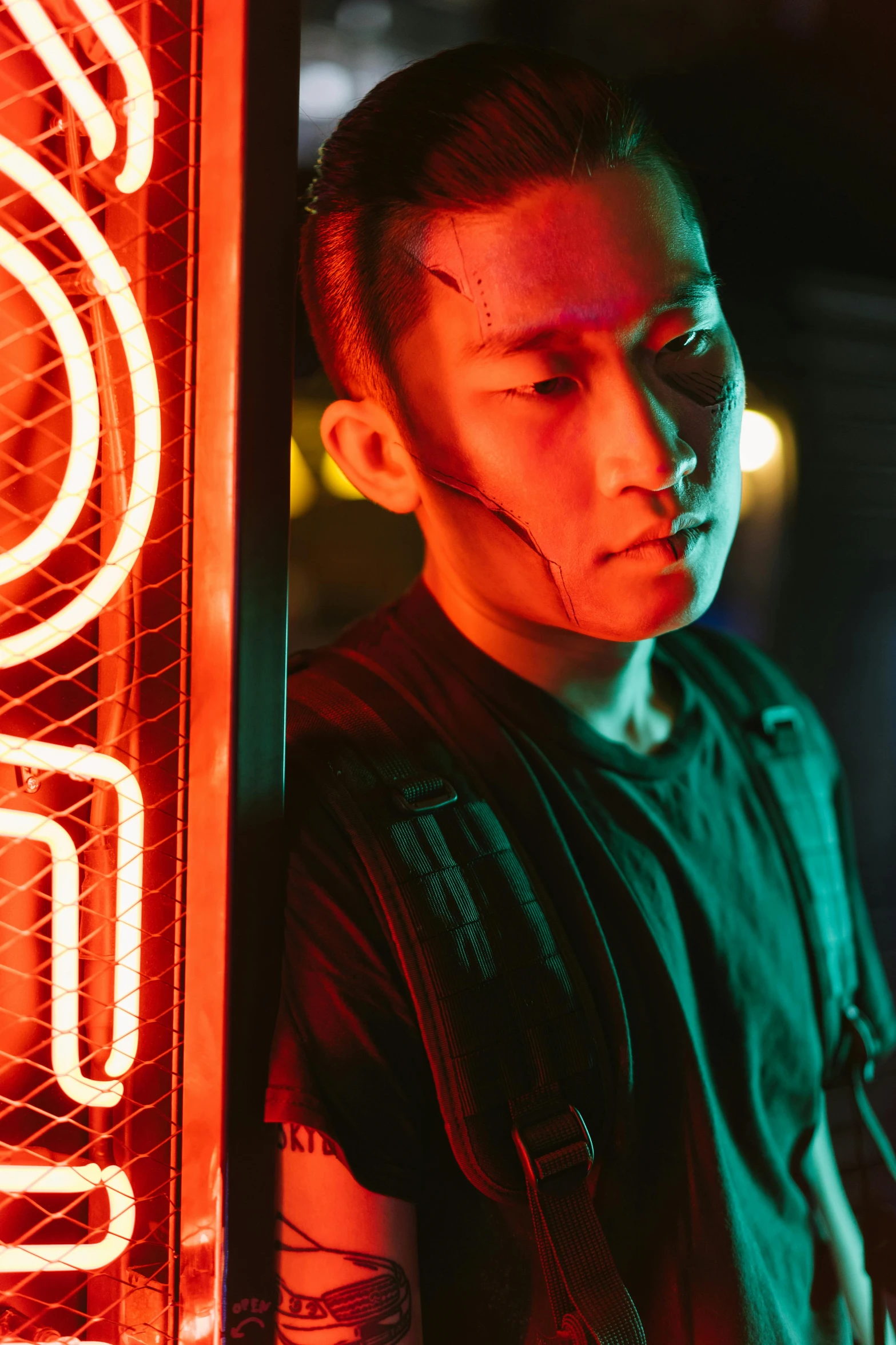 a man standing in front of a neon sign, inspired by Liam Wong, trending on pexels, portrait of rung, looking towards camera, production photo, wearing japanese techwear