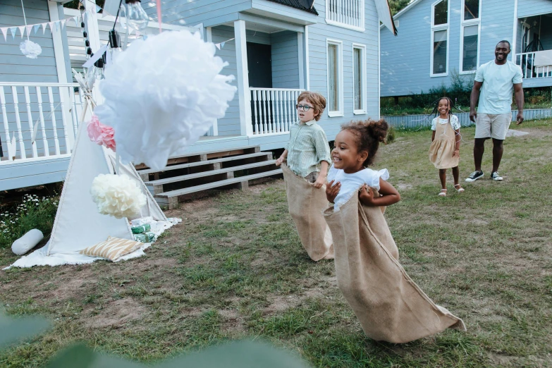 a group of people that are standing in the grass, playing, cottagecore, birthday party, white