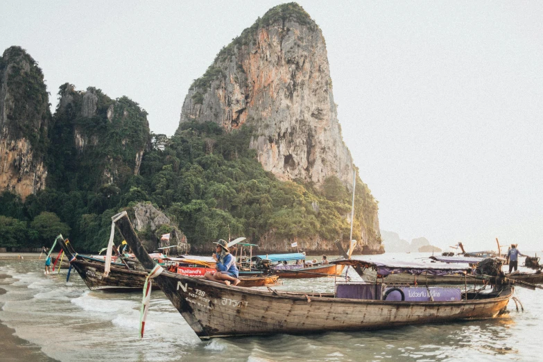 a group of boats sitting on top of a beach, inspired by Steve McCurry, pexels contest winner, thai architecture, wide film still, paul davey, a cozy