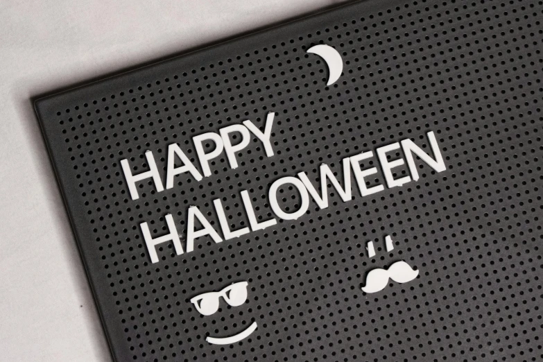 a sign that says happy halloween on it, tumblr, silicone patch design, floor grills, monochrome, product photograph