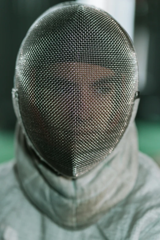 a close up of a person wearing a fencing mask, by Adam Marczyński, pexels contest winner, renaissance, mesh structure, sharp nose with rounded edges, portrait of metallic face, preparing to fight