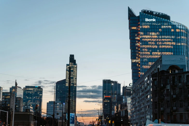 a city street filled with lots of traffic next to tall buildings, by Adam Marczyński, unsplash contest winner, bauhaus, at dusk at golden hour, 000 — википедия, brutalist buildings tower over, warsaw