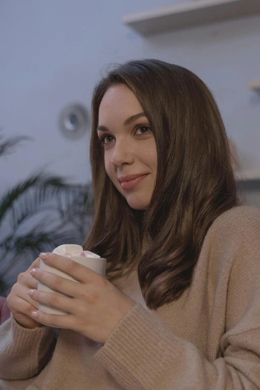 a woman sitting on a couch holding a cup of coffee, trending on reddit, renaissance, pokimane, close-up portrait film still, hot cocoa drink, medium head to shoulder shot