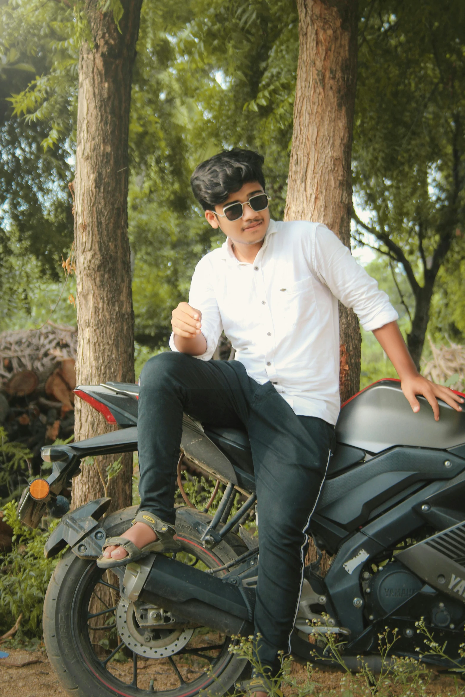 a man that is sitting on a motorcycle, by Max Dauthendey, pexels contest winner, sitting on a tree, white shirt and jeans, avatar image, teenager