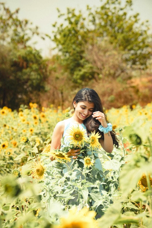 a woman standing in a field of sunflowers, by Max Dauthendey, pexels contest winner, romanticism, indian girl with brown skin, full body:: sunny weather::, medium format. soft light, portait photo profile picture