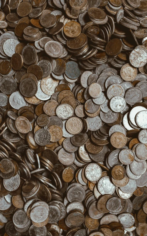 a pile of coins sitting on top of a table, by Jessie Algie, pexels, renaissance, high angle close up shot, thumbnail, background image, mixed materials