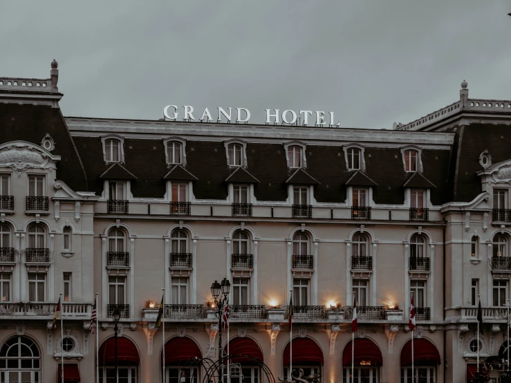 a large building with a sign that says grand hotel, by Julia Pishtar, pexels contest winner, northern france, high gradient, alessio albi, fan favorite