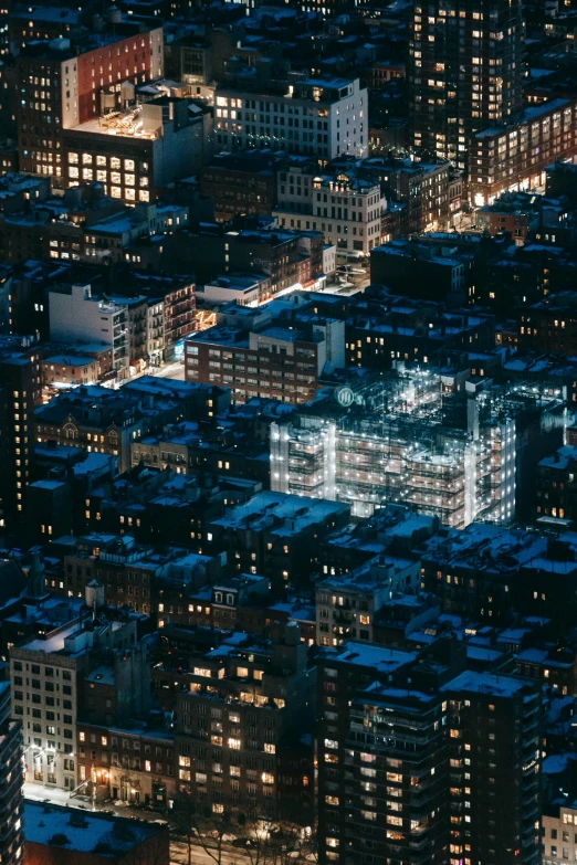 an aerial view of a city at night, unsplash contest winner, modernism, cramped new york apartment, stacked buildings, blue night, dark. no text