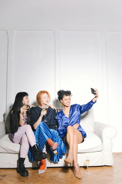 a group of people sitting on top of a white couch, inspired by Nan Goldin, trending on pexels, three women, selfie, full body photo, asian women