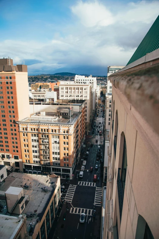 a view of a city from the top of a building, a photo, by Winona Nelson, unsplash, renaissance, long street, loomis, overwatch building, over-shoulder shot