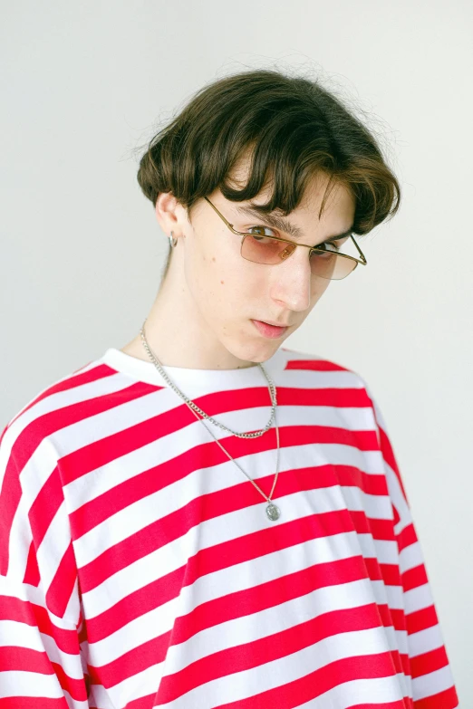 a young man wearing a red and white striped shirt, unsplash, neo-dada, wearing a gold chain, androgynous person, with sunglass, ((red)) baggy eyes